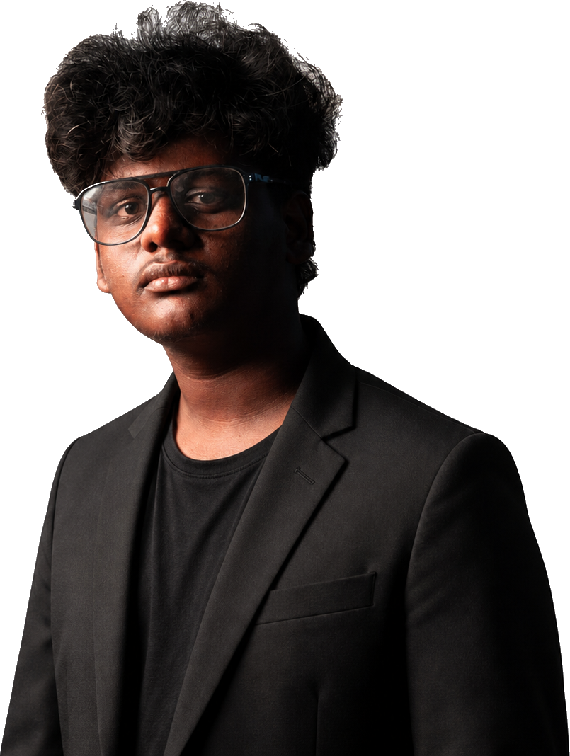 Portrait of Sam Sankar wearing glasses and a tailored black suit